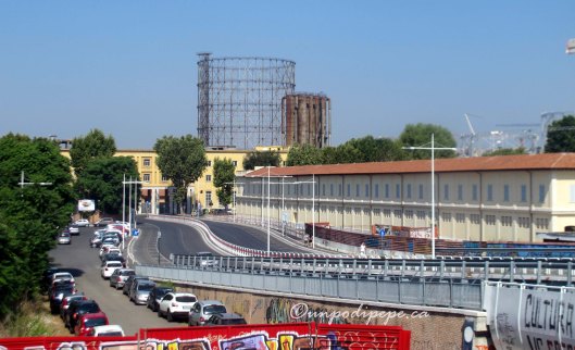 The view on exiting Garbatella Metro Stop.  Via Ostiense is in front, where the yellow building is.  Il Gasometro is behind it.  Centrale Montemartini is just to the left.  